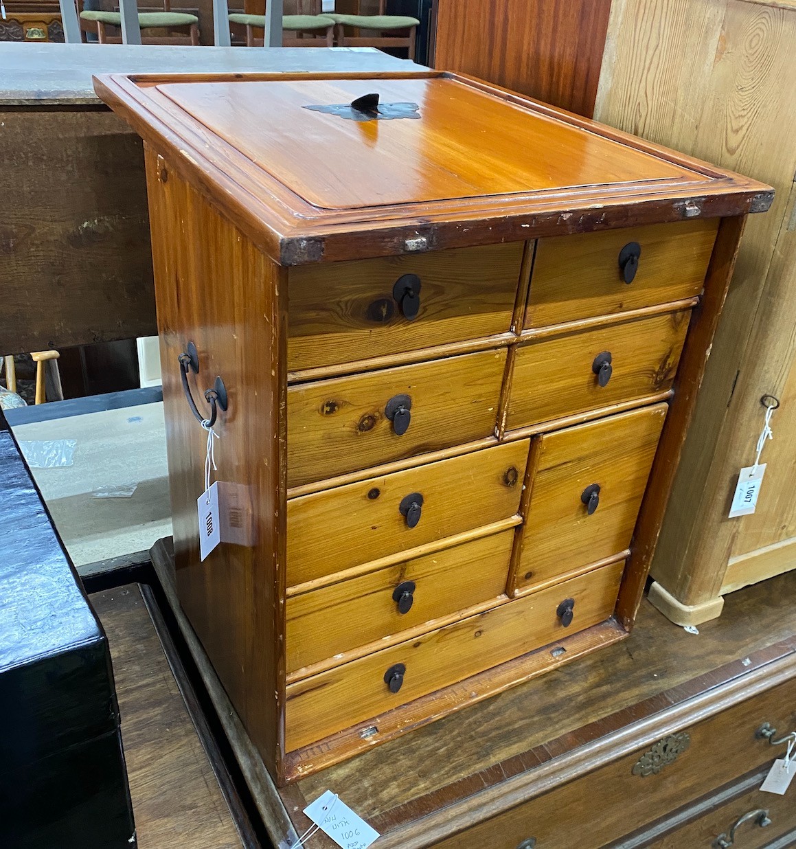 A Chinese pine cabinet housing an arrangement of eight drawers, width 48cm height 56cm